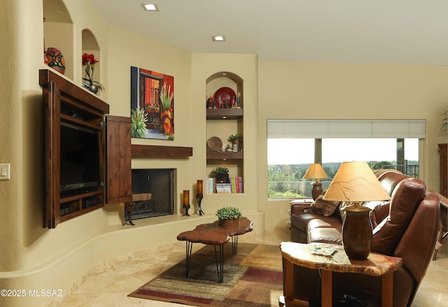 9971 N Desert Sky Rd, Oro Valley, AZ 85737 - living room featuring built in shelves and a fireplace with raised hearth