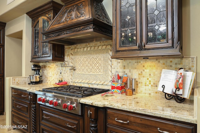 9971 N Desert Sky Rd, Oro Valley, AZ 85737 - kitchen featuring custom range hood, dark brown cabinetry, and backsplash