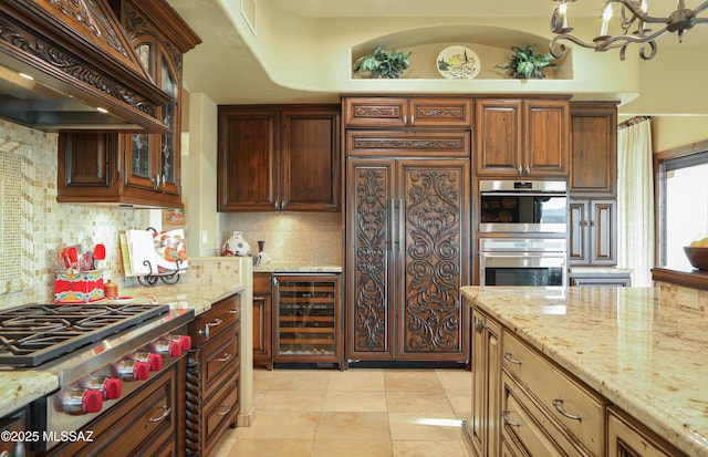 9971 N Desert Sky Rd, Oro Valley, AZ 85737 - kitchen featuring beverage cooler, stainless steel appliances, custom exhaust hood, backsplash, and light stone counters