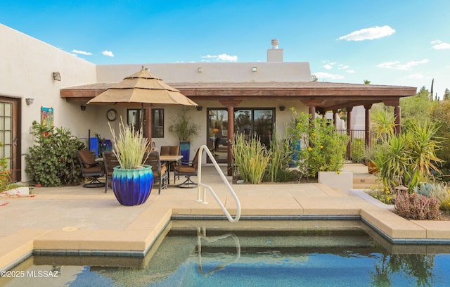 9971 N Desert Sky Rd, Oro Valley, AZ 85737 - back of property with stucco siding, a patio, a chimney, and an outdoor pool