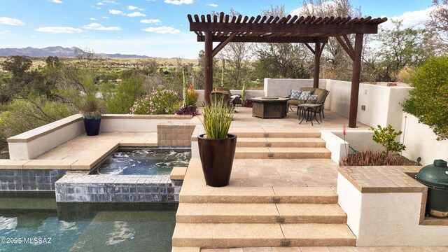 9971 N Desert Sky Rd, Oro Valley, AZ 85737 - view of patio / terrace featuring an in-ground hot tub, a mountain view, and an outdoor living space with a fire pit