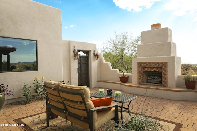 9971 N Desert Sky Rd, Oro Valley, AZ 85737 - view of patio / terrace with exterior fireplace