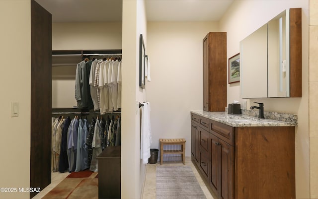 9971 N Desert Sky Rd, Oro Valley, AZ 85737 - bathroom with vanity, a spacious closet, and tile patterned flooring