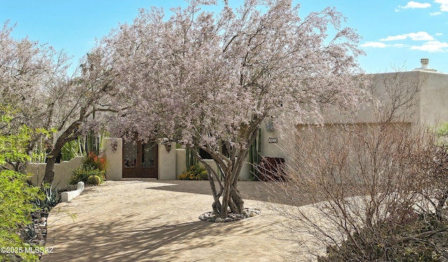 9971 N Desert Sky Rd, Oro Valley, AZ 85737 - adobe home with decorative driveway, stucco siding, and french doors
