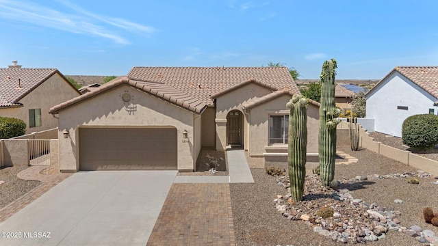 62742 E Oakwood Dr, Saddlebrooke, AZ 85739 - view of front of house featuring driveway, an attached garage, stucco siding, and a tile roof