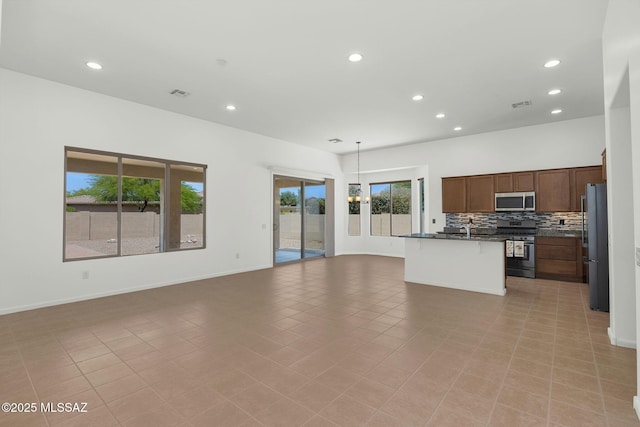 62742 E Oakwood Dr, Saddlebrooke, AZ 85739 - unfurnished living room featuring recessed lighting and baseboards