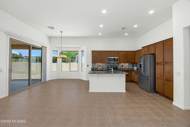 62742 E Oakwood Dr, Saddlebrooke, AZ 85739 - kitchen with appliances with stainless steel finishes, a chandelier, tasteful backsplash, recessed lighting, and a kitchen breakfast bar
