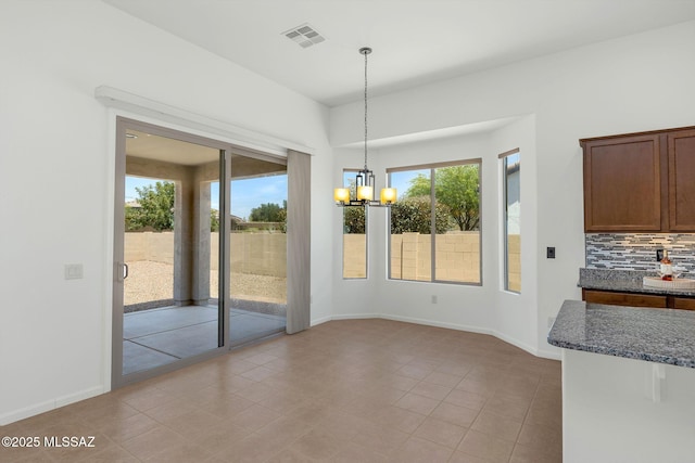 62742 E Oakwood Dr, Saddlebrooke, AZ 85739 - unfurnished dining area with a chandelier, baseboards, and light tile patterned flooring