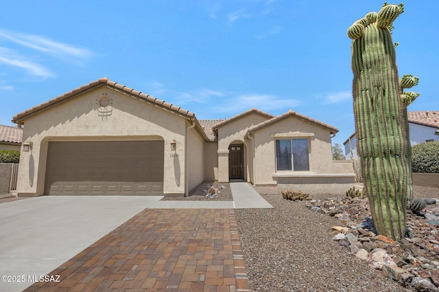 62742 E Oakwood Dr, Saddlebrooke, AZ 85739 - mediterranean / spanish-style house featuring stucco siding, concrete driveway, an attached garage, and a tiled roof