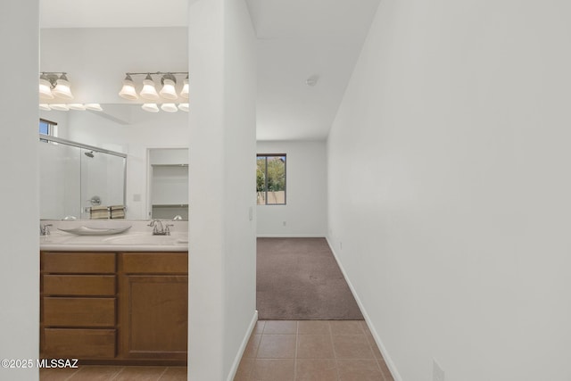 62742 E Oakwood Dr, Saddlebrooke, AZ 85739 - bathroom featuring a shower stall, double vanity, tile patterned flooring, and baseboards