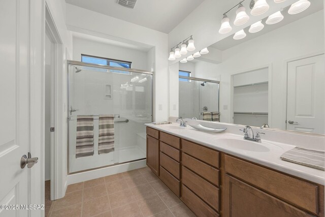 62742 E Oakwood Dr, Saddlebrooke, AZ 85739 - bathroom with a shower stall, a spacious closet, double vanity, and tile patterned flooring
