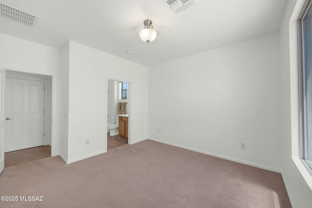 62742 E Oakwood Dr, Saddlebrooke, AZ 85739 - unfurnished bedroom with carpet, baseboards, and connected bathroom