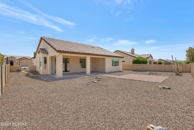 62742 E Oakwood Dr, Saddlebrooke, AZ 85739 - back of house featuring a tile roof, stucco siding, a patio area, and a fenced backyard