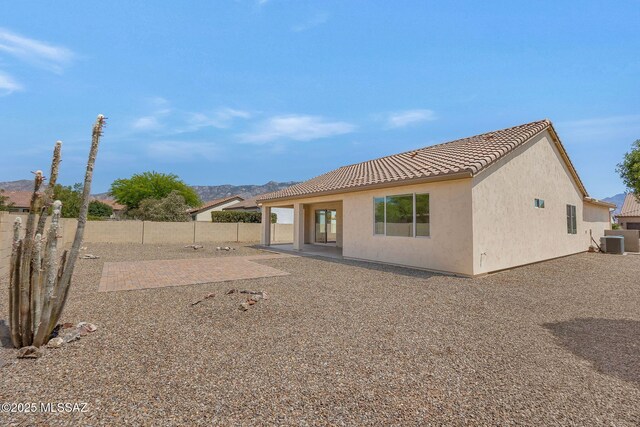 62742 E Oakwood Dr, Saddlebrooke, AZ 85739 - back of property with central air condition unit, a tile roof, a fenced backyard, a patio, and stucco siding