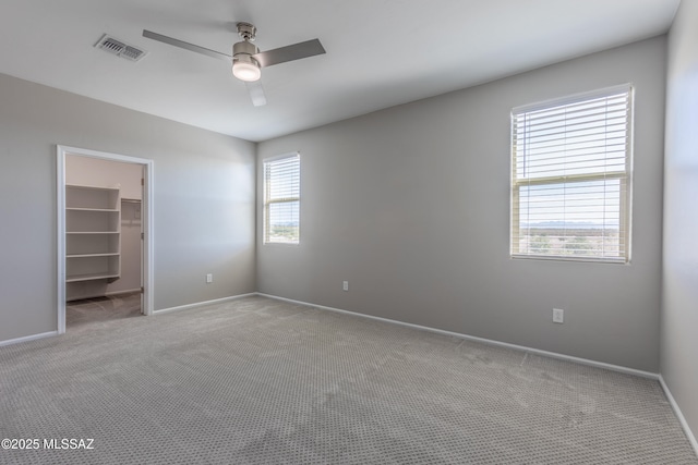 9734 E Miller Peak Trl, Tucson, AZ 85747 - unfurnished bedroom featuring carpet flooring, a spacious closet, and baseboards