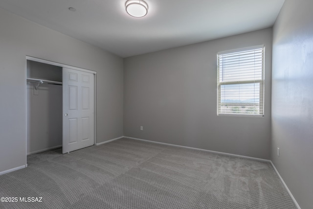 9734 E Miller Peak Trl, Tucson, AZ 85747 - unfurnished bedroom featuring carpet flooring, a closet, and baseboards