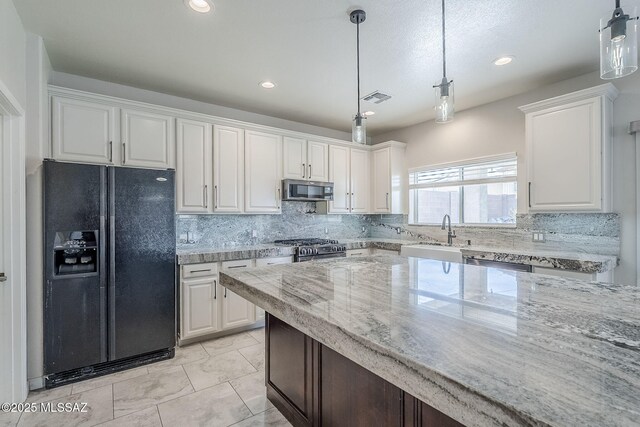 3526 E Farrier Dr, Tucson, AZ 85739 - kitchen with appliances with stainless steel finishes, a sink, white cabinetry, decorative backsplash, and recessed lighting