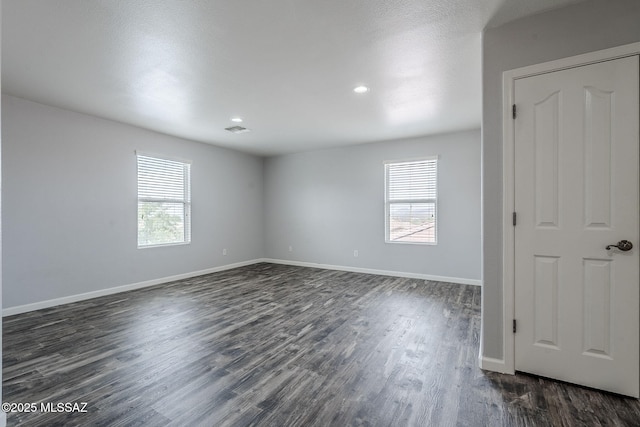 3526 E Farrier Dr, Tucson, AZ 85739 - spare room featuring healthy amount of natural light, dark wood-style flooring, baseboards, and recessed lighting