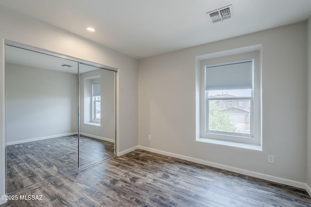 3526 E Farrier Dr, Tucson, AZ 85739 - unfurnished bedroom with multiple windows, wood finished floors, baseboards, a closet, and recessed lighting