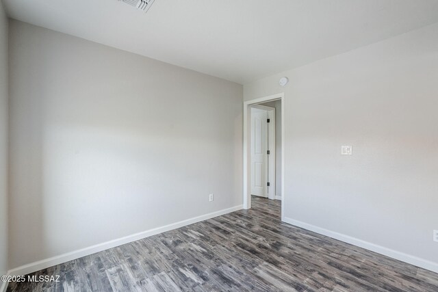 3526 E Farrier Dr, Tucson, AZ 85739 - empty room with dark wood-style floors, baseboards, and a smoke detector