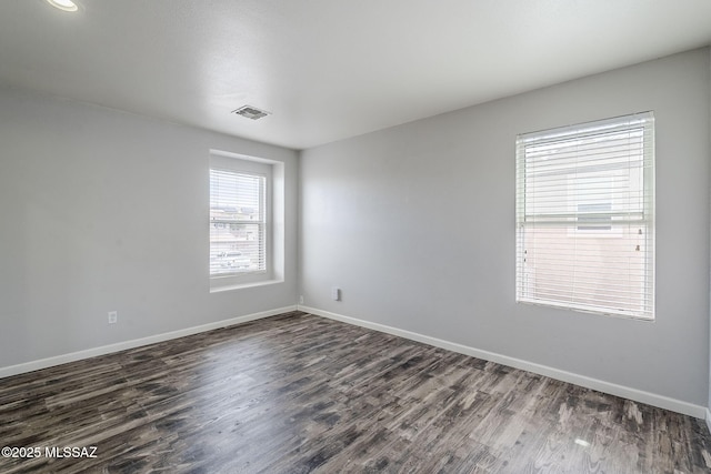 3526 E Farrier Dr, Tucson, AZ 85739 - unfurnished room featuring dark wood-type flooring and baseboards