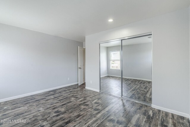 3526 E Farrier Dr, Tucson, AZ 85739 - unfurnished bedroom with dark wood-style flooring, baseboards, a closet, and recessed lighting