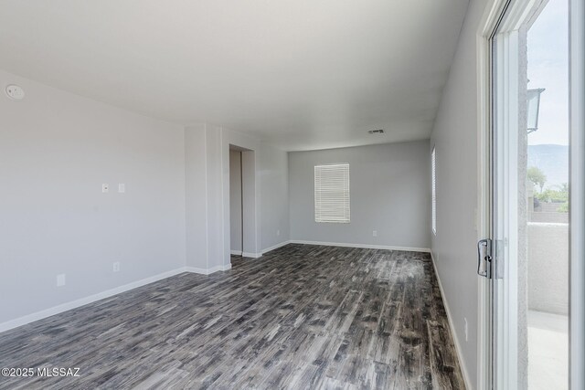 3526 E Farrier Dr, Tucson, AZ 85739 - spare room with dark wood-style floors and baseboards