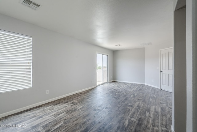 3526 E Farrier Dr, Tucson, AZ 85739 - unfurnished room featuring dark wood-type flooring and baseboards