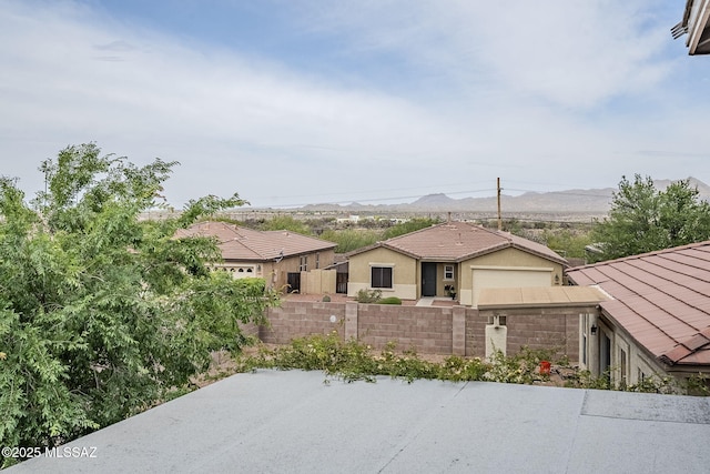 3526 E Farrier Dr, Tucson, AZ 85739 - view of front of home featuring fence, a mountain view, and stucco siding