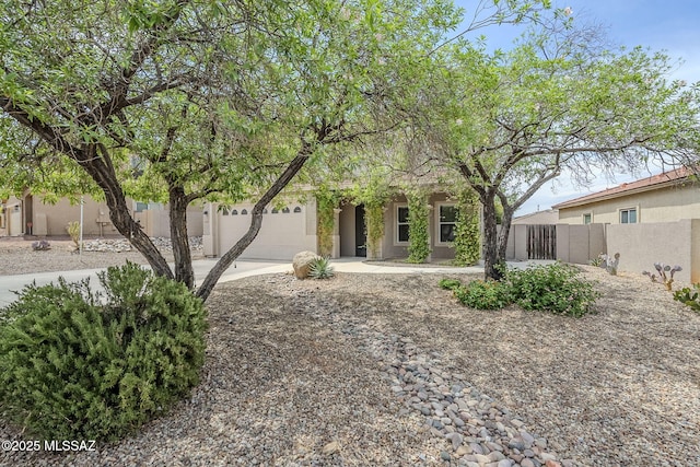 3526 E Farrier Dr, Tucson, AZ 85739 - obstructed view of property with fence, driveway, and stucco siding