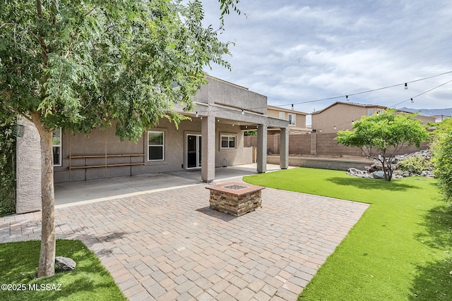 3526 E Farrier Dr, Tucson, AZ 85739 - rear view of property with an outdoor fire pit, a patio, and stucco siding