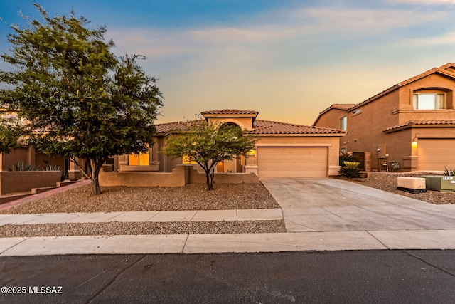 11874 N Verismo Dr, Tucson, AZ 85737 - mediterranean / spanish home featuring a garage, a tile roof, concrete driveway, and stucco siding