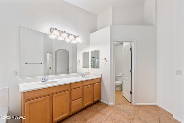 11874 N Verismo Dr, Tucson, AZ 85737 - full bath with double vanity, toilet, baseboards, and tile patterned flooring