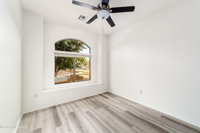 11874 N Verismo Dr, Tucson, AZ 85737 - spare room with light wood-style flooring, ceiling fan, and baseboards