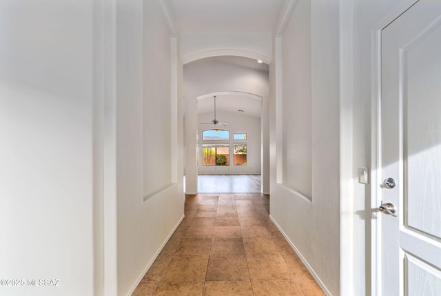 11874 N Verismo Dr, Tucson, AZ 85737 - hallway featuring arched walkways, lofted ceiling, and baseboards