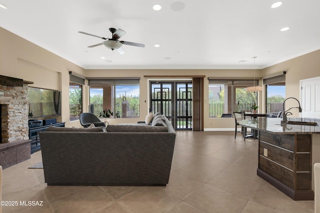 1808 W Quartz Rock Pl, Tucson, AZ 85737 - living area featuring plenty of natural light, a ceiling fan, crown molding, light tile patterned floors, and baseboards