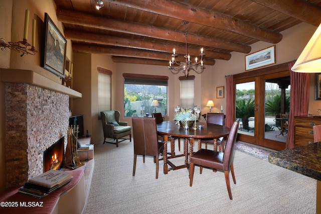 7020 N Chaparral Ave, Tucson, AZ 85718 - dining room with wood ceiling, a chandelier, french doors, a stone fireplace, and carpet