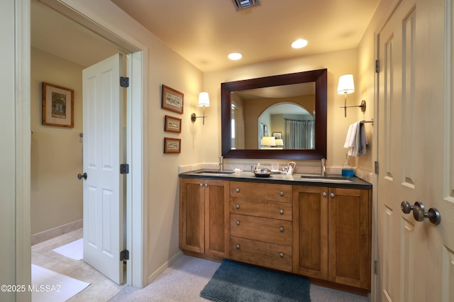 7020 N Chaparral Ave, Tucson, AZ 85718 - bathroom featuring double vanity, baseboards, and recessed lighting