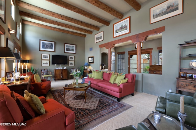 7020 N Chaparral Ave, Tucson, AZ 85718 - living room featuring a towering ceiling, decorative columns, beam ceiling, and carpet flooring