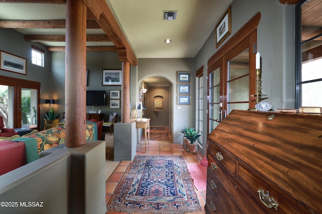 7020 N Chaparral Ave, Tucson, AZ 85718 - foyer entrance with arched walkways, french doors, decorative columns, light tile patterned flooring, and beam ceiling