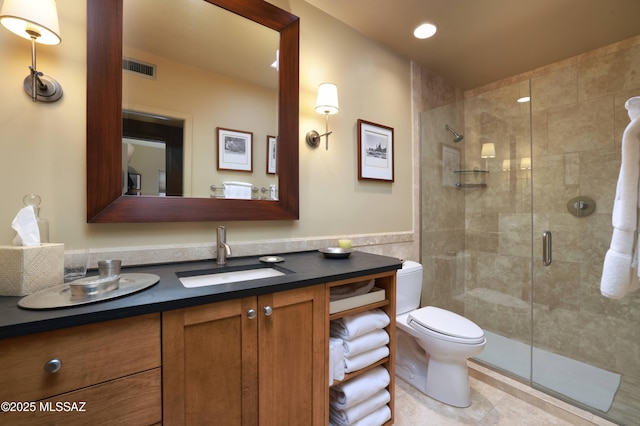 7020 N Chaparral Ave, Tucson, AZ 85718 - bathroom with toilet, a shower stall, vanity, tile walls, and a wainscoted wall