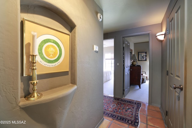 7020 N Chaparral Ave, Tucson, AZ 85718 - hallway with a textured wall, tile patterned flooring, and baseboards