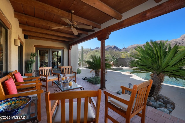 7020 N Chaparral Ave, Tucson, AZ 85718 - view of patio featuring a mountain view, a ceiling fan, and french doors