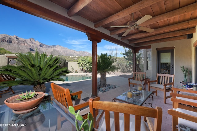 7020 N Chaparral Ave, Tucson, AZ 85718 - view of patio / terrace with a mountain view, a ceiling fan, and a fenced backyard