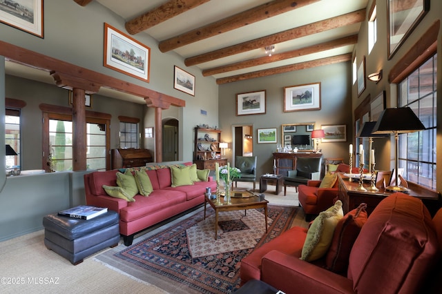 7020 N Chaparral Ave, Tucson, AZ 85718 - carpeted living area featuring beam ceiling, healthy amount of natural light, and a towering ceiling