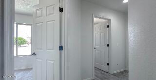 corridor with healthy amount of natural light and baseboards