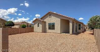 view of front of house featuring a fenced backyard and stucco siding