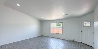 unfurnished living room featuring recessed lighting and wood finished floors