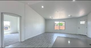unfurnished living room with recessed lighting and vaulted ceiling