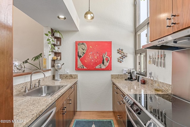 7622 E Callisto Cir Unit 204, Tucson, AZ 85715 - kitchen with a sink, light wood-type flooring, under cabinet range hood, brown cabinets, and stainless steel appliances
